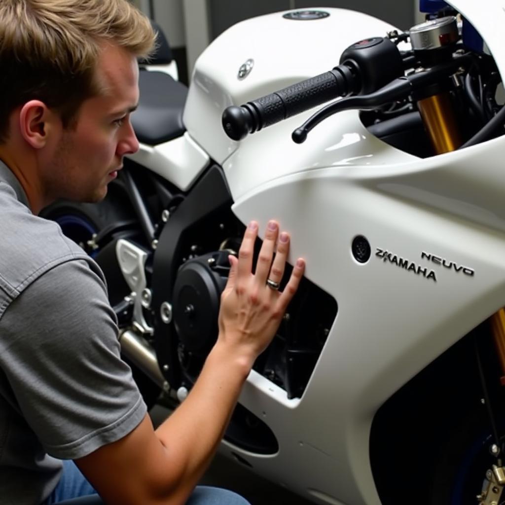 Carefully inspecting the bodywork of a Yamaha Nouvo 6